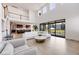 Open-concept living area featuring hardwood floors, modern décor, large sliding glass doors, and an open flow to the kitchen at 6677 Crossbridge Cir, Castle Rock, CO 80108