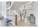 Open staircase with wooden railings, white risers, wood floors, and views of the front entryway at 6677 Crossbridge Cir, Castle Rock, CO 80108