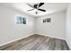 Light bedroom with laminate flooring and large windows offering outdoor views at 334 S Revere St, Aurora, CO 80012