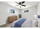 Bright bedroom with wood floors, ceiling fan, dresser, and large windows at 334 S Revere St, Aurora, CO 80012