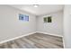 Bedroom featuring laminate flooring and natural light from two windows at 334 S Revere St, Aurora, CO 80012