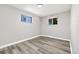 Bedroom featuring laminate flooring and natural light from two windows at 334 S Revere St, Aurora, CO 80012