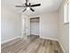 Bedroom featuring laminate flooring, closet, and neutral paint at 334 S Revere St, Aurora, CO 80012