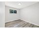 Neutral bedroom with laminate flooring and a window allowing natural light at 334 S Revere St, Aurora, CO 80012