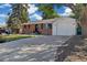 Charming brick home with a well-maintained lawn, mature trees, and an attached garage at 334 S Revere St, Aurora, CO 80012