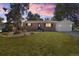 Charming brick home with an attached garage, mature trees, and a well-maintained front yard at 334 S Revere St, Aurora, CO 80012