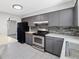 Updated kitchen featuring stainless steel appliances and tiled backsplash at 334 S Revere St, Aurora, CO 80012