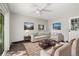 Inviting living room featuring stylish furnishings, a ceiling fan, and natural light from large windows at 334 S Revere St, Aurora, CO 80012