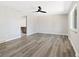 Bright, open space with modern floors, a ceiling fan, and a window providing natural light at 334 S Revere St, Aurora, CO 80012