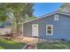 Newly renovated home with a charming entryway, modern lighting, and manicured front lawn at 1764 W Atlantic Pl, Denver, CO 80223
