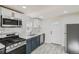 Modern kitchen featuring stainless steel appliances, white cabinetry, and marble backsplash at 1764 W Atlantic Pl, Denver, CO 80223