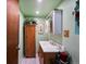 Well-lit bathroom with a vanity, medicine cabinet, and ample storage space at 6801 W 52Nd Ave, Arvada, CO 80002