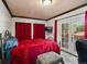 Cozy bedroom featuring a red bedspread, French doors to the outside, and decorative lighting at 6801 W 52Nd Ave, Arvada, CO 80002