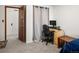 Bedroom with a desk, chair, and computer, with a small end table next to the bed at 6801 W 52Nd Ave, Arvada, CO 80002