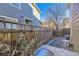 Private backyard features a wooden fence, a tree, and a small patio area perfect for outdoor relaxation at 2032 Spruce St, Denver, CO 80238