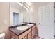 Bathroom featuring neutral tile, double sinks and bright vanity lighting at 2032 Spruce St, Denver, CO 80238