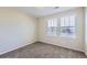 Bright bedroom featuring neutral carpet, walls and two windows at 2032 Spruce St, Denver, CO 80238