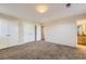 Bright bedroom featuring neutral carpet, walls and multiple closets at 2032 Spruce St, Denver, CO 80238