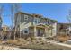 Attractive two-story townhome showcases a covered entrance and complements the surrounding community at 2032 Spruce St, Denver, CO 80238