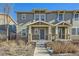 Charming two-story townhome with a welcoming front porch and well-maintained landscaping in a desirable neighborhood at 2032 Spruce St, Denver, CO 80238