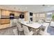 Open kitchen and dining area with stylish furnishings, fireplace, and modern appliances at 2032 Spruce St, Denver, CO 80238