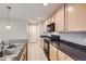 Well-lit kitchen featuring modern appliances, dark countertops, and ample cabinet space at 2032 Spruce St, Denver, CO 80238