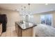 Kitchen island overlooking spacious carpeted living area and glass sliding doors at 2032 Spruce St, Denver, CO 80238