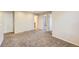 Bright living room with neutral walls, plush carpeting, and multiple doorways offering easy access to other areas of the home at 2032 Spruce St, Denver, CO 80238