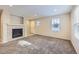 Open living room with fireplace, large windows, and neutral carpet at 2032 Spruce St, Denver, CO 80238