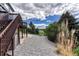 Backyard featuring a patio, a second-story deck, rock landscaping, and tall grass at 3630 Sawgrass Trl, Castle Rock, CO 80109