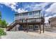 Spacious, multi-level deck is attached to a home with rock landscaping and stairs at 3630 Sawgrass Trl, Castle Rock, CO 80109