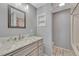 Bathroom with a vanity, marble countertop, a large mirror, and tiled floors at 3630 Sawgrass Trl, Castle Rock, CO 80109