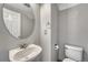 Bathroom with a pedestal sink, toilet, and modern fixtures at 3630 Sawgrass Trl, Castle Rock, CO 80109
