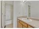 Bathroom with light wood cabinets, a tub/shower combination, and large mirror at 3630 Sawgrass Trl, Castle Rock, CO 80109
