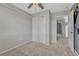 Bedroom with carpet, ceiling fan, a closet, and an open door to a hall at 3630 Sawgrass Trl, Castle Rock, CO 80109