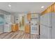Bright kitchen featuring wood cabinets, white appliances, and convenient laundry space at 3630 Sawgrass Trl, Castle Rock, CO 80109