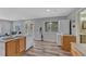 A well-lit kitchen with wood laminate flooring, stainless steel sink, and adjacent laundry area at 3630 Sawgrass Trl, Castle Rock, CO 80109