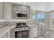 Renovated kitchen with stainless steel appliances, mosaic backsplash and light filled windows at 3630 Sawgrass Trl, Castle Rock, CO 80109