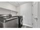 Modern laundry room featuring gray front load washer and dryer units at 3630 Sawgrass Trl, Castle Rock, CO 80109