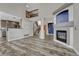 Bright and open living room with gray flooring, a fireplace, and seamless transition to the kitchen area at 3630 Sawgrass Trl, Castle Rock, CO 80109