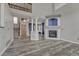 Open-concept living room featuring a fireplace, staircase, and stylish gray flooring, perfect for entertaining at 3630 Sawgrass Trl, Castle Rock, CO 80109