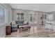 Open living space features hard surface floors, gray sofa, and french doors at 3630 Sawgrass Trl, Castle Rock, CO 80109