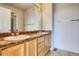 Bathroom with double sink vanity, spacious mirror, and a glimpse of the shower at 18766 E Yale Cir # A, Aurora, CO 80013