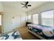 A bedroom is furnished with two twin beds, a ceiling fan, and a closet for storage at 18766 E Yale Cir # A, Aurora, CO 80013