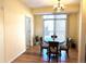 Well-lit dining area with round table, chandelier, and large sliding glass door at 18766 E Yale Cir # A, Aurora, CO 80013