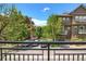 Townhome exterior with green trees and a parking lot at 18766 E Yale Cir # A, Aurora, CO 80013