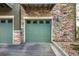 Garage with teal door and brick surround at 18766 E Yale Cir # A, Aurora, CO 80013