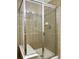 Modern shower with glass door, tiled walls, and a built-in seat at 18766 E Yale Cir # A, Aurora, CO 80013