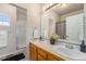 Bathroom vanity featuring double sinks, a large mirror, and updated lighting at 225 Longspur Dr, Brighton, CO 80601