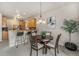 Dining area with adjacent breakfast bar and a view into the kitchen and living areas at 225 Longspur Dr, Brighton, CO 80601